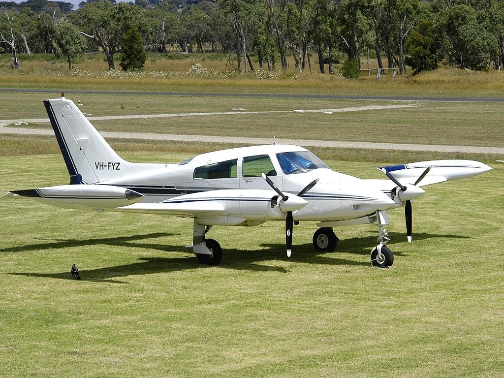 Cessna 310 parked on grass